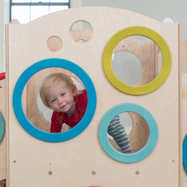 Boy looking through indoor window panel
