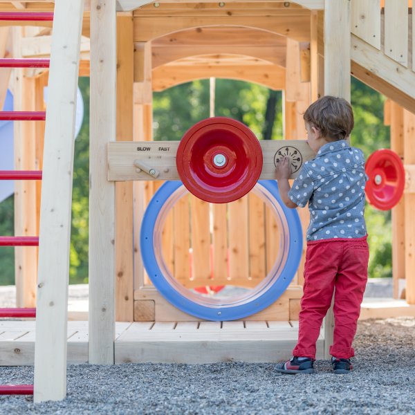 Boy playing on commercial outdoor playset