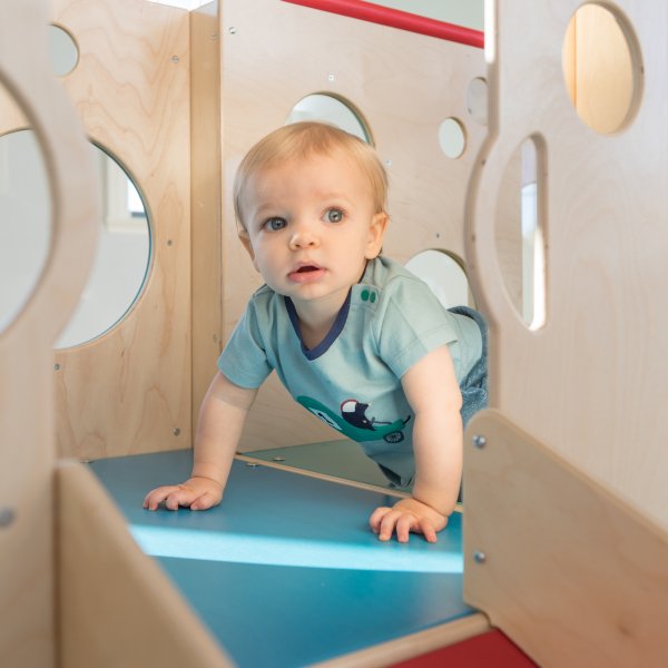 Child playing on a commercial indoor playset