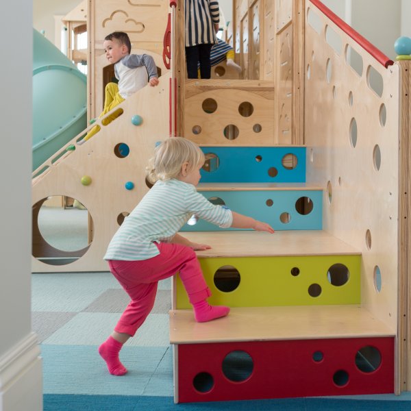Children playing on a commercial indoor playset