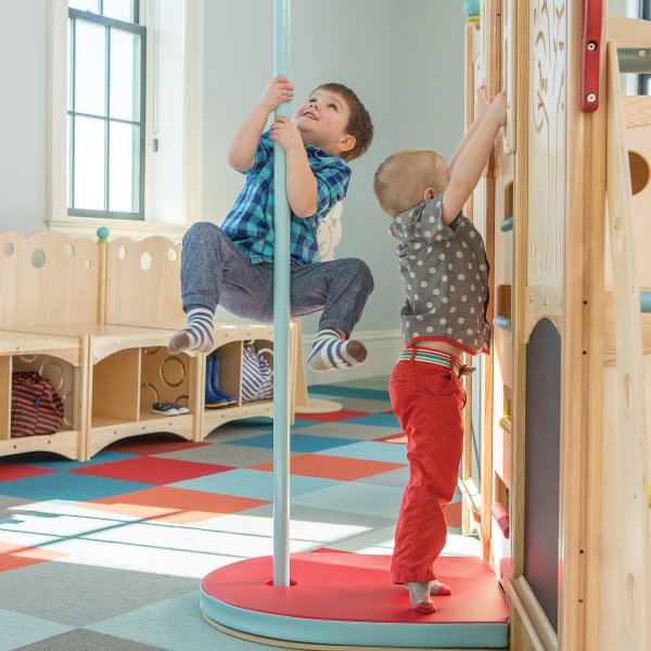 Children playing on a commercial intdoor playset