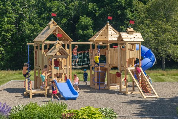 Kids playing on outdoor commercial playset